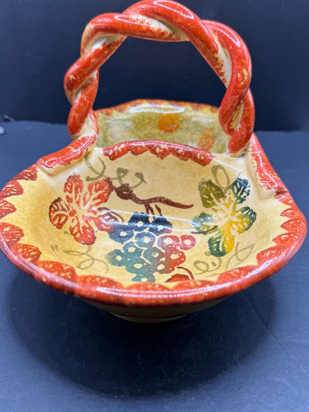 Hand-Painted Ceramic Basket with Red Handle and Floral Motif